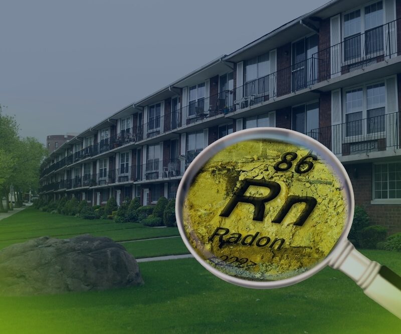 A magnifying glass focuses on the chemical element symbol for radon in front of a residential building, illustrating the process of a radon test in Philadelphia.